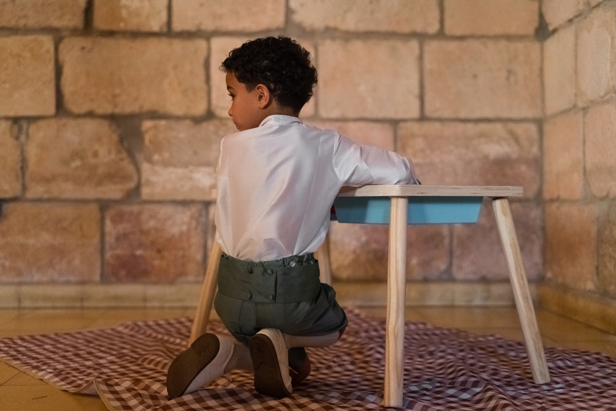 Young boy focused on an activity at the kids lounge table