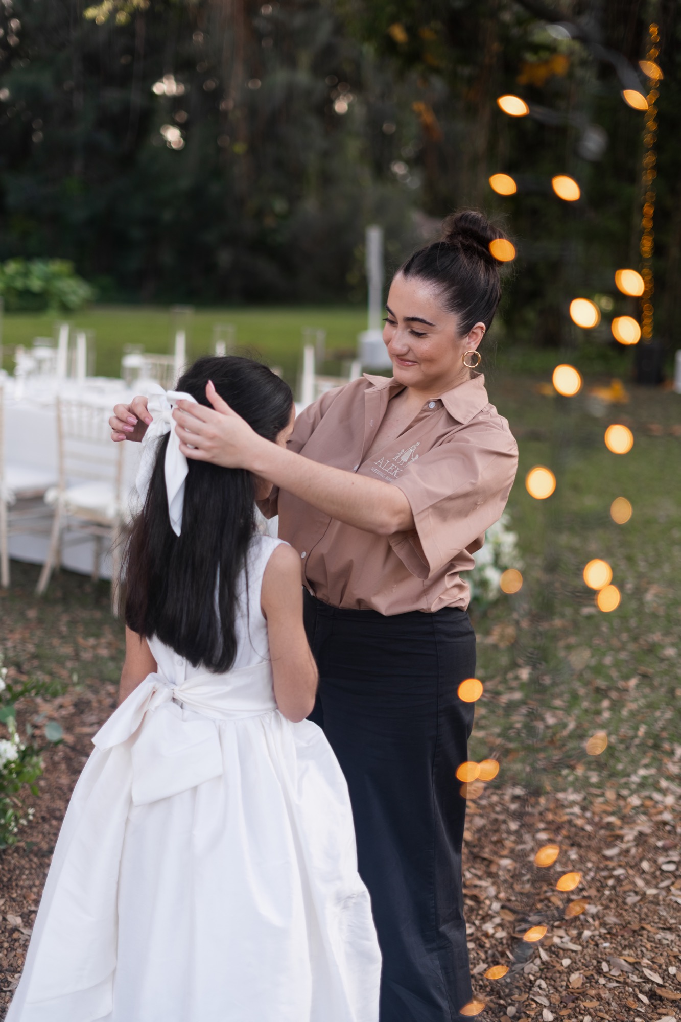 Alekai nanny caring for a flower girl before the ceremony