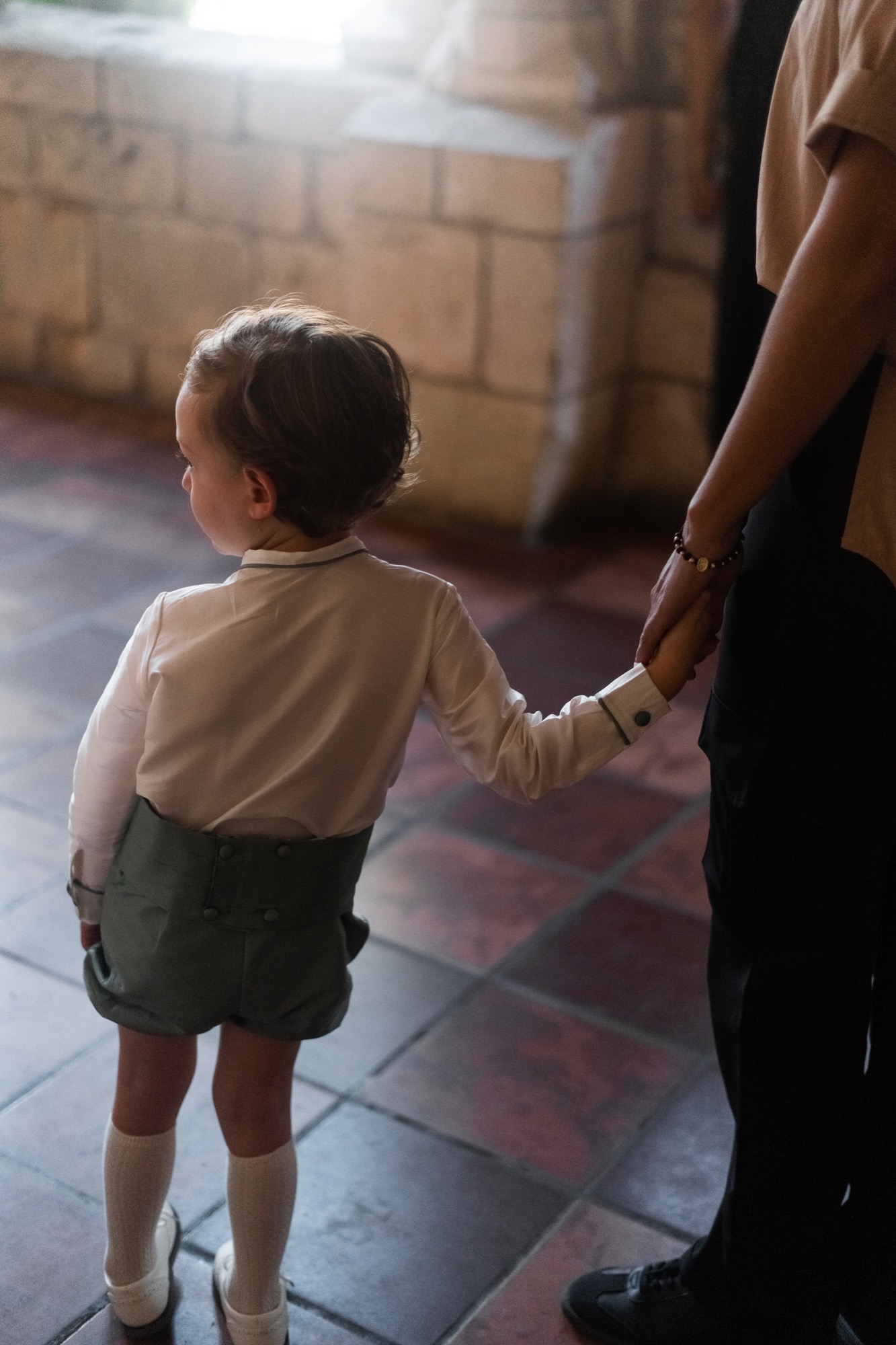 Toddler holding hands with an Alekai nanny for comfort and peace of mind